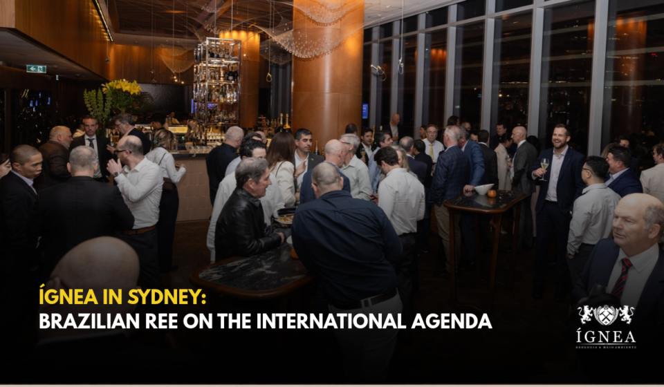 Guests mingling in a room with large windows during the sunset party in Sydney. Title: Ígnea in Sydney: Brazilian Rare Earths on the International Agenda.