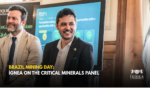 Giancarlo Silva smiling during the first panel at Brazil Mining Day, in front of the panel slide. Title: Brazil Mining Day: Ígnea on the Critical Minerals Panel.